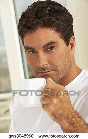 Portrait of a mid adult man holding a mug View Large Photo Image Stock Image - Portrait of a mid adult man holding a mug. Fotosearch