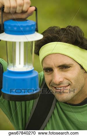 Portrait of a mid adult man holding a lantern View Large Photo Image Stock Image - Portrait of a mid adult man holding a lantern. Fotosearch