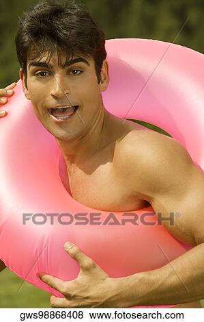 Portrait of a mid adult man in an inflatable ring View Large Photo Image Stock Photo - Portrait of a mid adult man in an inflatable ring. Fotosearch