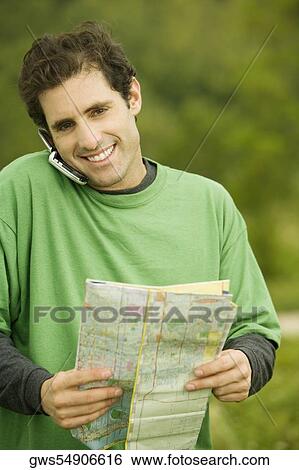 Stock Photograph - Portrait of a mid adult man talking on a mobile phone. Fotosearch