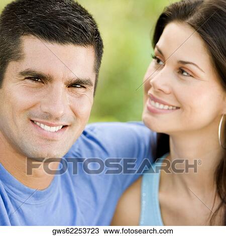 Portrait of a mid adult man with his arm around a young woman View Large Photo Image Stock Image - Portrait of a mid adult man with his arm around a young woman. Fotosearch