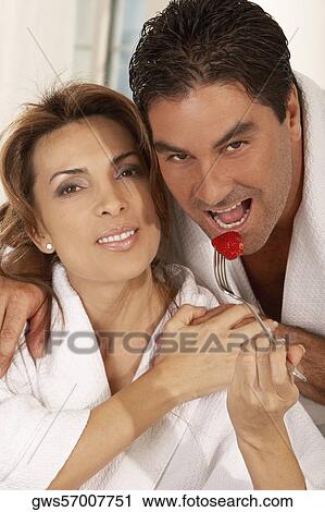 Portrait of a mid adult woman feeding a mid adult man a strawberry View Large Photo Image Stock Image - Portrait of a mid adult woman feeding a mid adult man a strawberry. Fotosearch