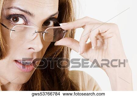 Portrait of a mid adult woman holding her eyeglasses View Large Photo Image Picture - Portrait of a mid adult woman holding her eyeglasses. Fotosearch