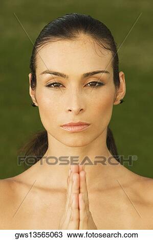 Stock Image - Portrait of a mid adult woman meditating. Fotosearch
