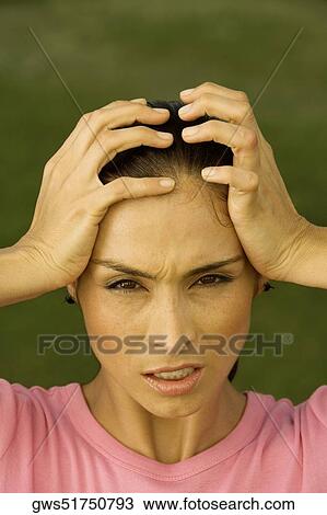 Portrait of a mid adult woman with her hands on her head View Large Photo Image Stock Image - Portrait of a mid adult woman with her hands on her head. Fotosearch