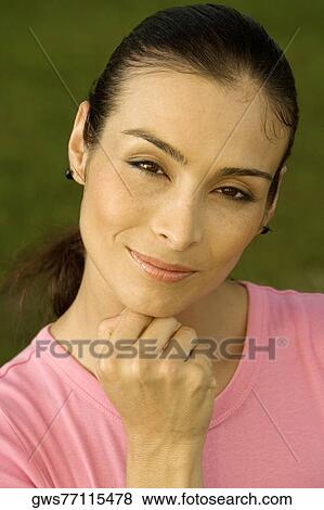Portrait of a mid adult woman with her hand on her chin View Large Photo Image Stock Photo - Portrait of a mid adult woman with her hand on her chin. Fotosearch