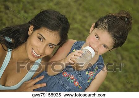 Portrait of a mother holding her daughter View Large Photo Image Stock Photography - Portrait of a mother holding her daughter. Fotosearch