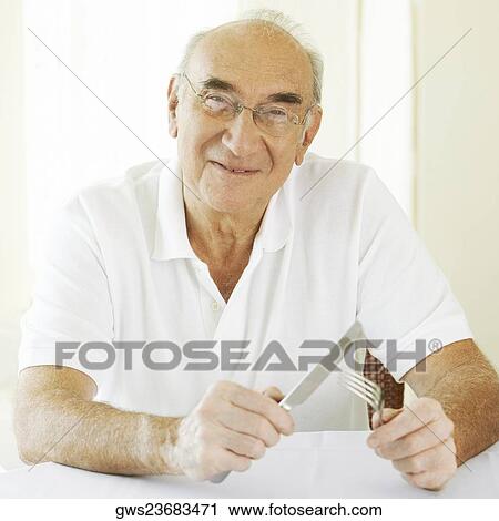 Portrait of a senior man holding a fork with a table knife View Large Photo Image Stock Image - Portrait of a senior man holding a fork with a table knife. Fotosearch