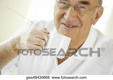 Portrait of a senior man holding a coffee cup View Large Photo Image Stock Photo - Portrait of a senior man holding a coffee cup. Fotosearch
