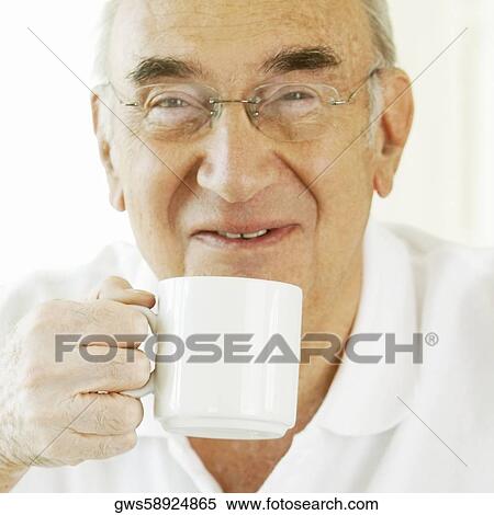 Portrait of a senior man holding a coffee cup View Large Photo Image Stock Photography - Portrait of a senior man holding a coffee cup. Fotosearch