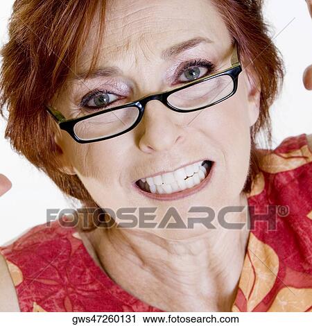 Portrait of a senior woman clenching her teeth View Large Photo Image Stock Image - Portrait of a senior woman clenching her teeth. Fotosearch