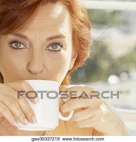 Portrait of a senior woman drinking a cup of coffee View Large Photo Image Stock Photo - Portrait of a senior woman drinking a cup of coffee. Fotosearch