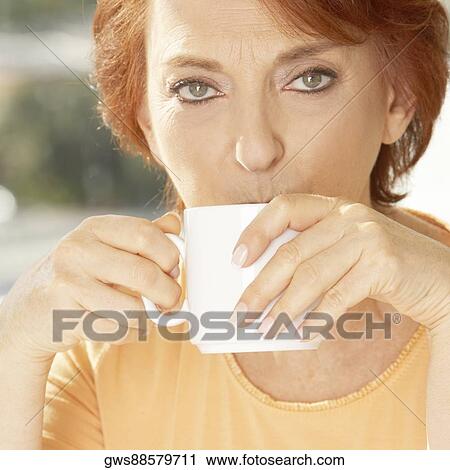 Portrait of a senior woman drinking coffee View Large Photo Image Stock Image - Portrait of a senior woman drinking coffee. Fotosearch