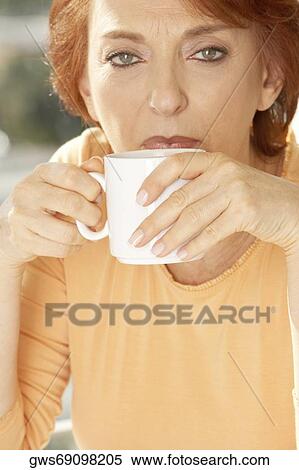 Portrait of a senior woman drinking coffee View Large Photo Image Stock Photography - Portrait of a senior woman drinking coffee. Fotosearch