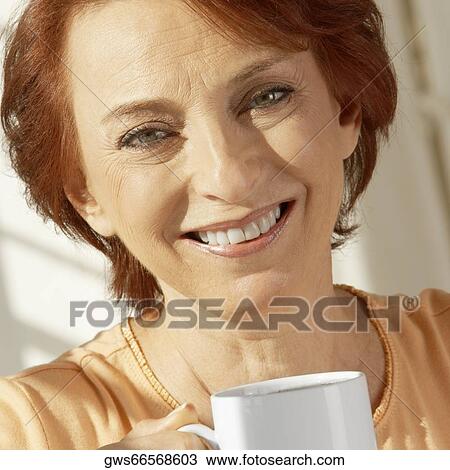 Portrait of a senior woman holding a coffee cup View Large Photo Image Stock Image - Portrait of a senior woman holding a coffee cup. Fotosearch