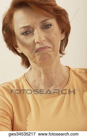 Stock Photo - Portrait of a senior woman making a face. Fotosearch