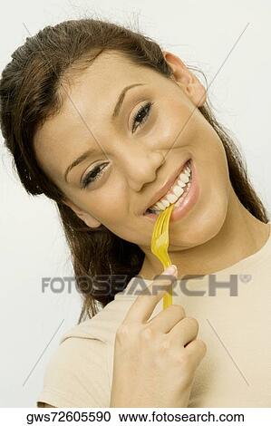 Portrait of a teenage girl holding a fork in her mouth View Large Photo Image Stock Image - Portrait of a teenage girl holding a fork in her mouth. Fotosearch