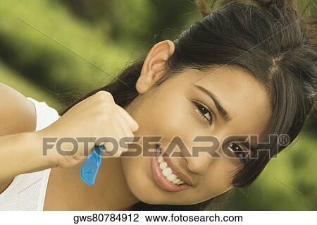 Stock Image - Portrait of a teenage girl holding a table knife. Fotosearch