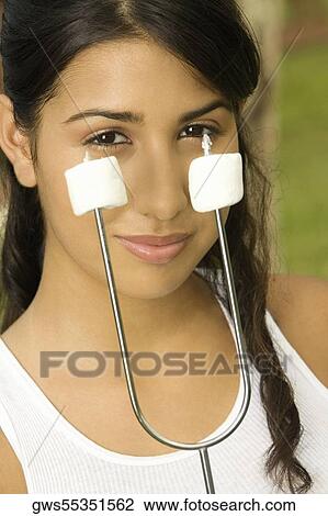 Portrait of a teenage girl holding marshmallows on a skewer View Large Photo Image Stock Image - Portrait of a teenage girl holding marshmallows on a skewer. Fotosearch