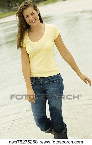 Portrait of a teenage girl walking on the beach View Large Photo Image Stock Photo - Portrait of a teenage girl walking on the beach. Fotosearch