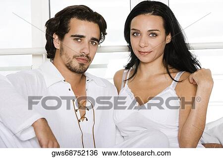 Portrait of a young couple sitting View Large Photo Image Stock Photograph - Portrait of a young couple sitting. Fotosearch