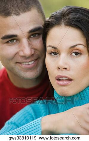 Stock Photo - Portrait of a young couple smiling. Fotosearch