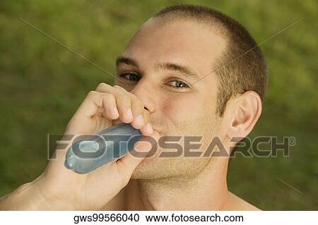Portrait of a young man blowing a condom View Large Photo Image Stock Image - Portrait of a young man blowing a condom. Fotosearch
