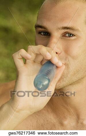 Portrait of a young man blowing a condom View Large Photo Image Stock Photograph - Portrait of a young man blowing a condom. Fotosearch