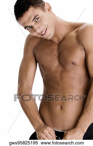 Portrait of a young man buttoning his pants View Large Photo Image Stock Photography - Portrait of a young man buttoning his pants. Fotosearch