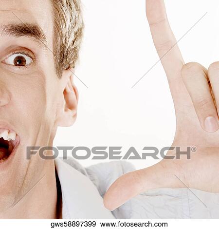 Portrait of a young man gesturing with his hand View Large Photo Image Stock Photo - Portrait of a young man gesturing with his hand. Fotosearch