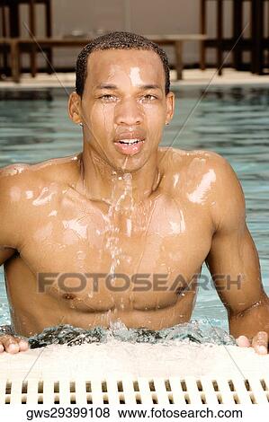 Portrait of a young man in a swimming pool View Large Photo Image Stock Photo - Portrait of a young man in a swimming pool. Fotosearch
