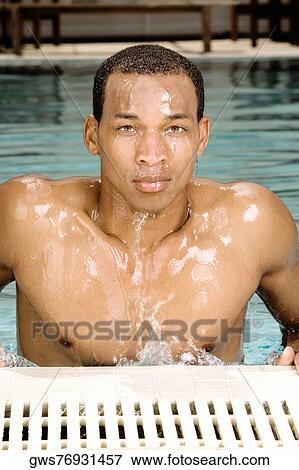 Portrait of a young man in a swimming pool View Large Photo Image Stock Photo - Portrait of a young man in a swimming pool. Fotosearch