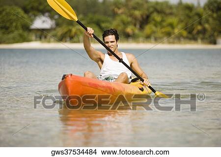 Picture - Portrait of a young man kayaking. Fotosearch