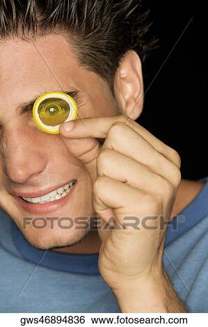 Portrait of a young man looking through a condom View Large Photo Image Stock Photograph - Portrait of a young man looking through a condom. Fotosearch