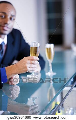 Portrait of a young man sitting at a bar counter View Large Photo Image Stock Image - Portrait of a young man sitting at a bar counter. Fotosearch