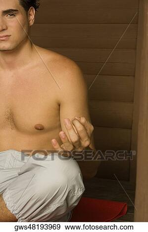Portrait of a young man sitting in a lotus position meditating View Large Photo Image Stock Photo - Portrait of a young man sitting in a lotus position meditating. Fotosearch