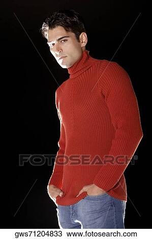 Portrait of a young man standing with his hands in his pockets View Large Photo Image Stock Image - Portrait of a young man standing with his hands in his pockets. Fotosearch