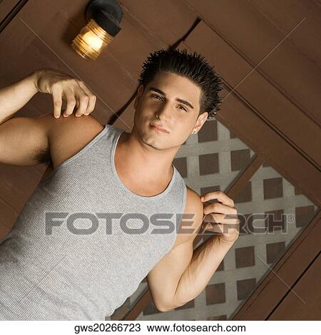 Stock Image - Portrait of a young man stretching his arms. Fotosearch