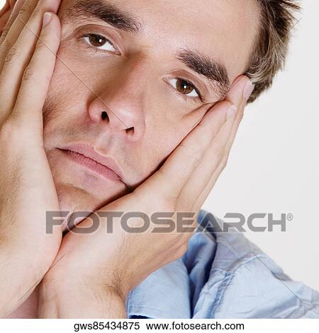Portrait of a young man thinking with his hands on his chin View Large Photo Image Stock Photography - Portrait of a young man thinking with his hands on his chin. Fotosearch