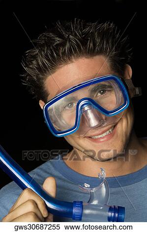 Portrait of a young man wearing a scuba mask and holding a snorkel View Large Photo Image Stock Photography - Portrait of a young man wearing a scuba mask and holding a snorkel. Fotosearch