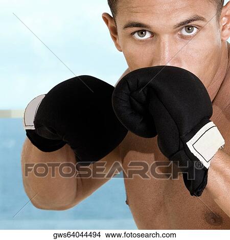 Portrait of a young man wearing boxing gloves View Large Photo Image Picture - Portrait of a young man wearing boxing gloves. Fotosearch