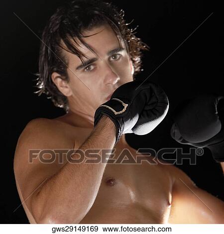 Portrait of a young man wearing boxing gloves View Large Photo Image Stock Photo - Portrait of a young man wearing boxing gloves. Fotosearch