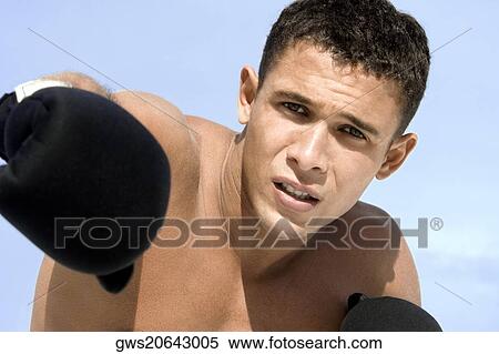 Portrait of a young man wearing boxing gloves View Large Photo Image Stock Photography - Portrait of a young man wearing boxing gloves. Fotosearch