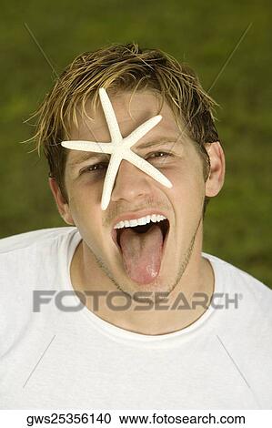 Portrait of a young man with a starfish on his face View Large Photo Image Stock Image - Portrait of a young man with a starfish on his face. Fotosearch