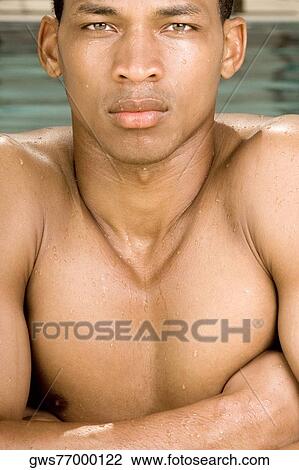 Portrait of a young man with his arms crossed View Large Photo Image Stock Image - Portrait of a young man with his arms crossed. Fotosearch