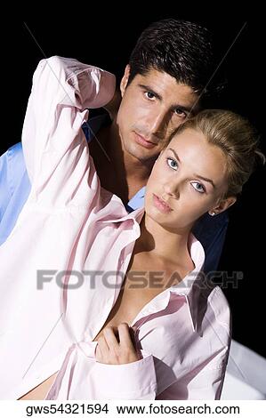 Portrait of a young woman and a mid adult man embracing each other View Large Photo Image Picture - Portrait of a young woman and a mid adult man embracing each other. Fotosearch