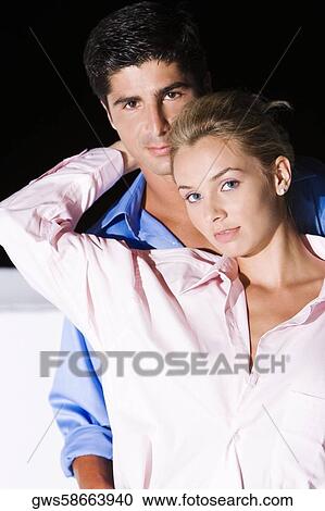 Portrait of a young woman and a mid adult man embracing each other View Large Photo Image Stock Image - Portrait of a young woman and a mid adult man embracing each other. Fotosearch