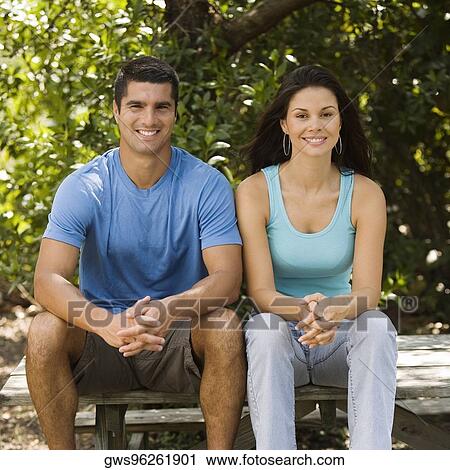 Portrait of a young woman and a mid adult man sitting together View Large Photo Image Stock Image - Portrait of a young woman and a mid adult man sitting together. Fotosearch