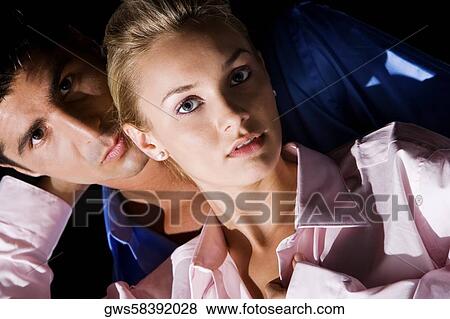 Portrait of a young woman and a mid adult man embracing each other View Large Photo Image Stock Photo - Portrait of a young woman and a mid adult man embracing each other. Fotosearch