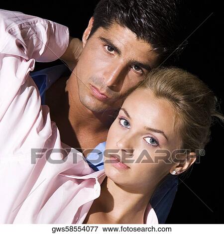Portrait of a young woman and a mid adult man embracing each other View Large Photo Image Stock Photo - Portrait of a young woman and a mid adult man embracing each other. Fotosearch